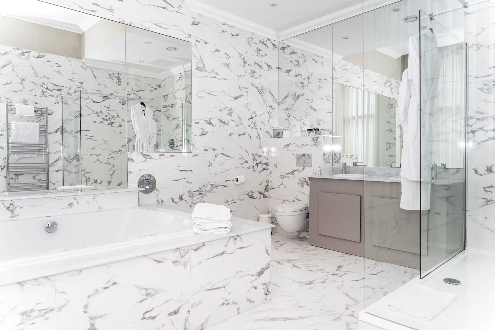 Chrome basin mixer on a white countertop basin in a bright bathroom